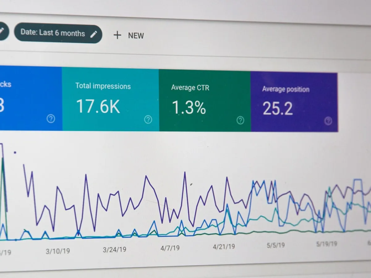 Close-up of a computer monitor showing a search engine analytics dashboard with clicks, impressions, and ranking charts, representing GiveTurn's SEO service